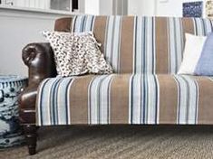 a living room with a striped couch and blue vases