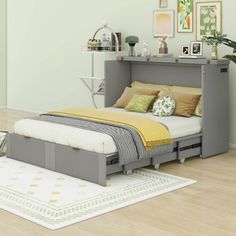 a bed sitting in the middle of a room next to a dresser and rug on top of a hard wood floor