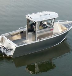 a small boat is in the middle of the water, with its door open to let people inside