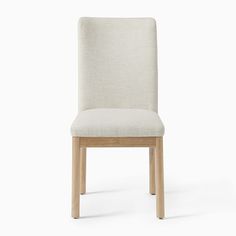 a chair that is upholstered with a white fabric and wood frame, on a white background