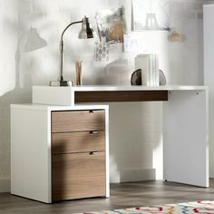 a white desk with two drawers and a lamp