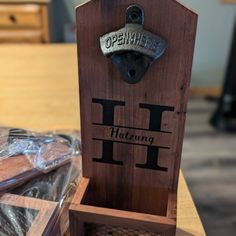 an open wine bottle opener sitting on top of a wooden box