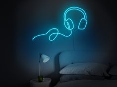 a bed with headphones on it in a dark room next to a night light