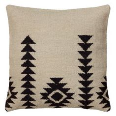 a black and white pillow with trees on it