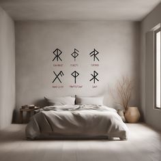 a bed sitting in a bedroom next to a window with arrows drawn on the wall