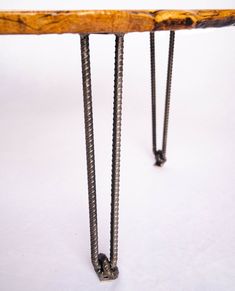 a wooden bench with metal legs and nails on the backrest, against a white background