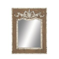 an ornate wooden frame mirror with white trimmings and carvings on the top, against a