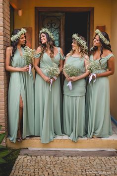 the bridesmaids are all dressed in mint green gowns and flower crowns for their wedding