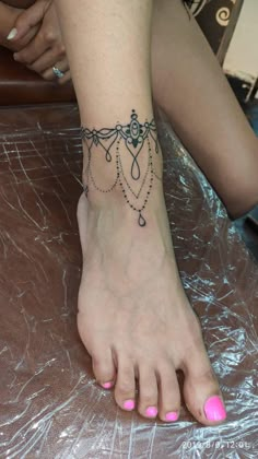 a woman's foot with a tattoo on it