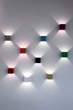 several square lights are mounted on the wall