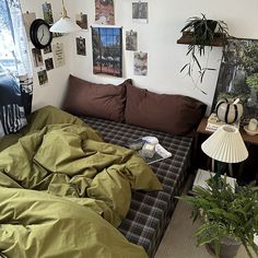 a living room filled with lots of furniture and plants on top of the couches