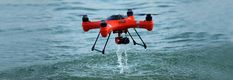 an orange and black remote controlled watercraft flying over the ocean with text that reads, buy best waterfoam drone for sale at affordable price