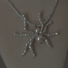 a snowflake made out of beads and pearls