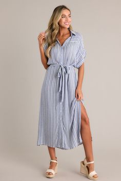 Go bold with the Embrace The Day Blue Stripe Midi Shirt Dress. Flaunt your style with this playful and quirky dress that features a midi length and a stylish blue stripe pattern. Be ready to take on the day with confidence and make a statement wherever you go. This blue stripe midi dress features a collared v-neckline. a functional button front. a self tie drawstring belt. functional pockets. side slits. and a flowing silhouette.  100% Rayon  Unlined  Hand Wash Cold  Manufactured in China  Designed in The USA  Model is wearing a size small Quirky Dress, Stripe Midi Dress, Blue Stripes Pattern, Sorority Rush Dresses, Halter Bridesmaid Dress, Rush Dresses, The Embrace, Striped Midi Dress, Black Dresses Casual