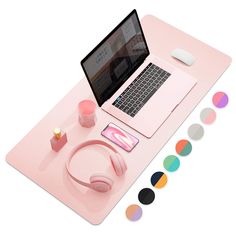 a laptop computer sitting on top of a pink desk with different colored circles around it