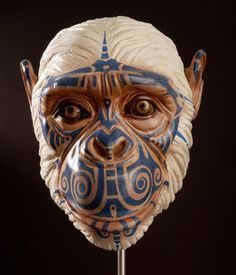 a blue and white mask on a stick