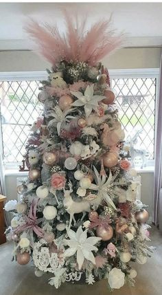 a decorated christmas tree with pink and white ornaments