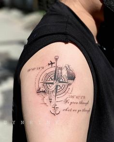 a man with a compass tattoo on his arm