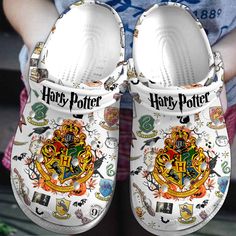 a pair of harry potter shoes with hogwart's crest on them