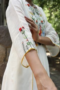 White dress with multi colored resham embroidery in duck and floral motifs. Comes with plain chanderi pant.
Components: 2
Pattern: Embroidered
Type Of Work: Floral and Duck
Neckline: Notched
Sleeve Type: Bell
Fabric: Handwoven Chanderi
Color: White
Other Details: 
Gathered details
Tassel on yoke
Side panels
Occasion: Work - Aza Fashions Applique Kurta, Resham Embroidery, Applique Work, Kurti Patterns, Casual Indian Fashion, Suits Design, Kurta Designs Women, Embroidery Suits Design, Embroidery Designs Fashion