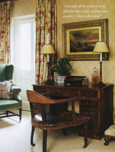 an old fashioned desk and chair in a living room