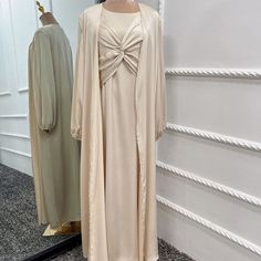 This Lux Two Piece Set is made from high-quality satin, and includes a long sleeve inner dress with chest design and a long sleeve open abaya in a matching color. Available in 6 beautiful colors. Elegant Solid Color Abaya For Fall, Elegant Solid Abaya For Fall, Solid Long Sleeve Dresses For Eid, Evening Solid Color Maxi Length Abaya, Evening Solid Maxi Length Abaya, Formal Spring Abaya With Long Sleeves, Spring Formal Long Sleeve Abaya, Evening Maxi Length Solid Abaya, Elegant Long-sleeve Abaya For Spring