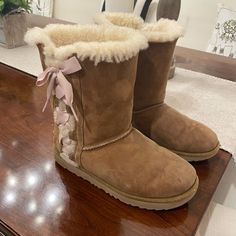 Worn Only A Few Times And Generally In Excellent Used/Like New Condition Except For Some Minor Wear To Front Of Left Boot As Pictured. Women’s Ugg Bailey Bow Ii, Chestnut With Pink Satin Bows. Uggs With Bows On Side, Cute Shoes Uggs, Uggs Cute, Uggs 2000s, Pink Uggs With Bows, Pink Ugg Boots, Cute Uggs, Ugg Coquette, Uggs With Bows