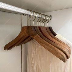 several wooden hangers are hanging on a rail