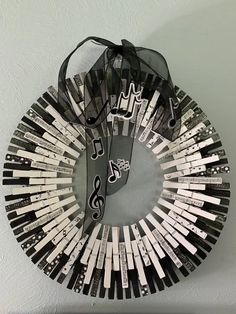 a circular mirror with musical notes on it and a string hanging from the wall behind it