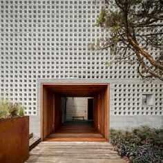 an entrance to a building with wooden doors