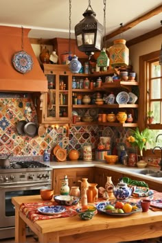 a kitchen filled with lots of different types of plates and bowls on top of a wooden table