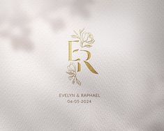 the logo for evelyn & raphael is shown in gold on white paper with leaves and flowers