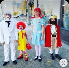 three children dressed in costumes standing next to each other with clowns on their faces