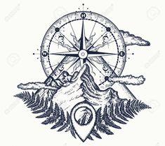 a compass with mountains and trees around it