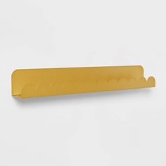 a yellow paper holder on a white wall