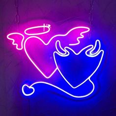 a neon sign with an angel holding a heart on it's back and wings in the air