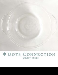 an empty glass plate sitting on top of a white tablecloth with the words dots connection