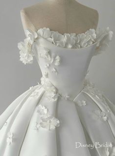 a white wedding dress with flowers on it