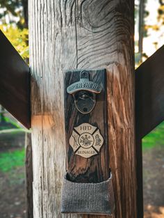 a wooden pole with a skateboard hanging from it's side and the words fire department on it