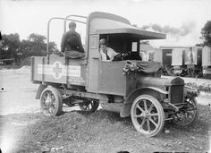 an old truck with two men sitting in it