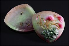 two pieces of art glass with flowers on them