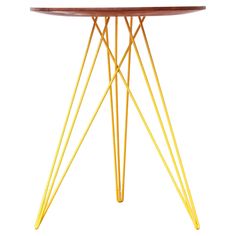 a round table with yellow legs and a wooden top