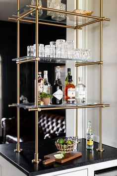 a bar cart with bottles and glasses on it