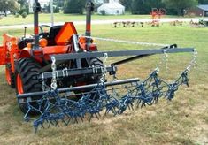 an orange tractor with chains attached to it