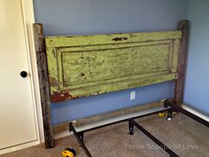 an old wooden headboard is being made into a bed frame