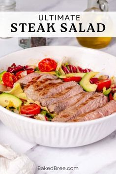 steak salad with tomatoes, cucumbers and avocado in a white bowl