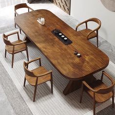 a wooden table with chairs around it and a phone on the top of each table