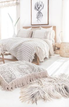 a bedroom with white walls and neutral decor