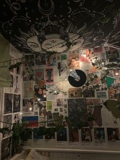 the ceiling is covered with many pictures and lights hanging from it's side wall