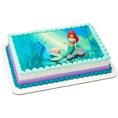 the little mermaid cake is decorated with blue and purple icing